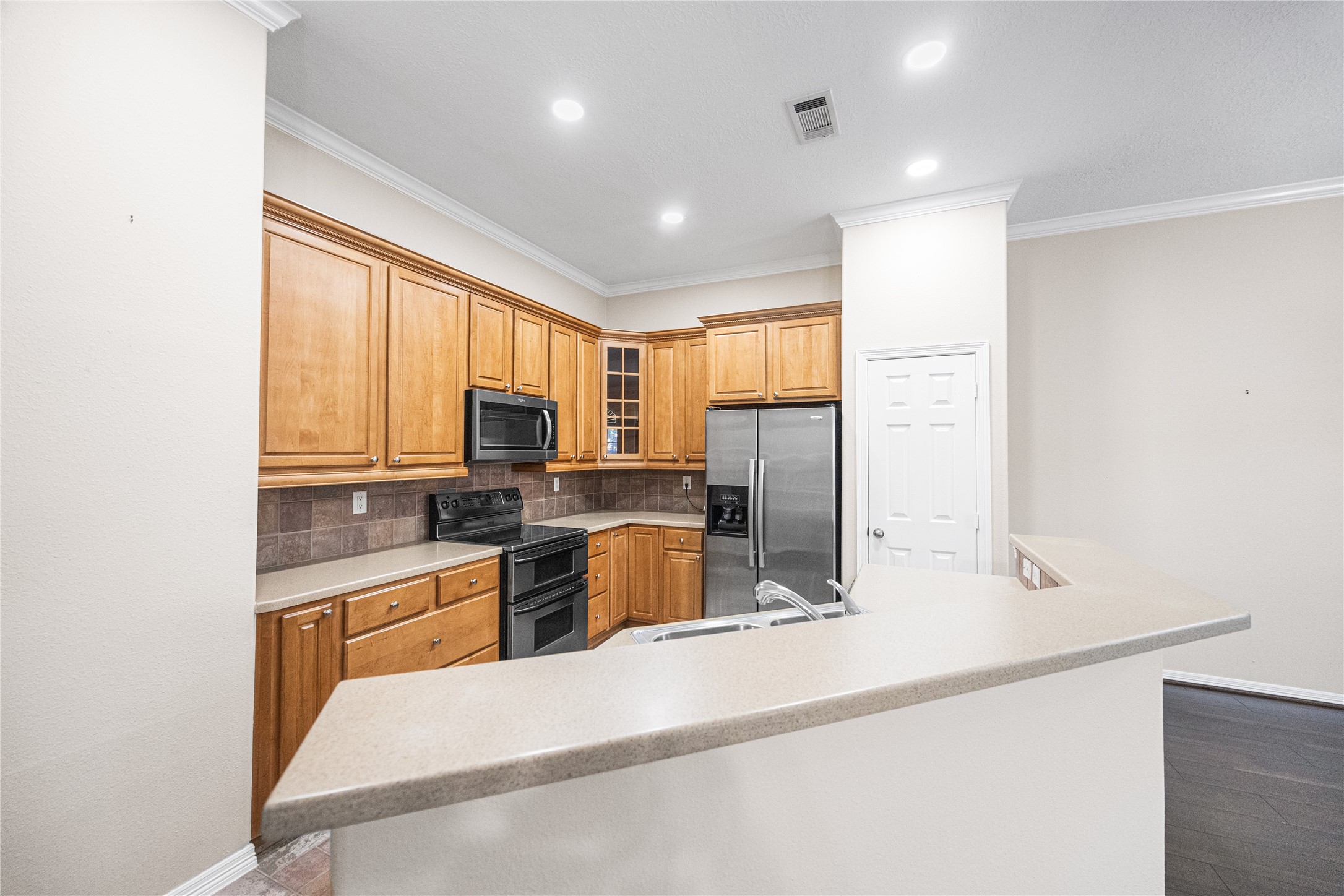 12755 Mill Ridge Drive, Unit 703 Cypress, TX 77429 - Photo 15 of 31 a kitchen with stainless steel appliances granite countertop sink refrigerator and microwave