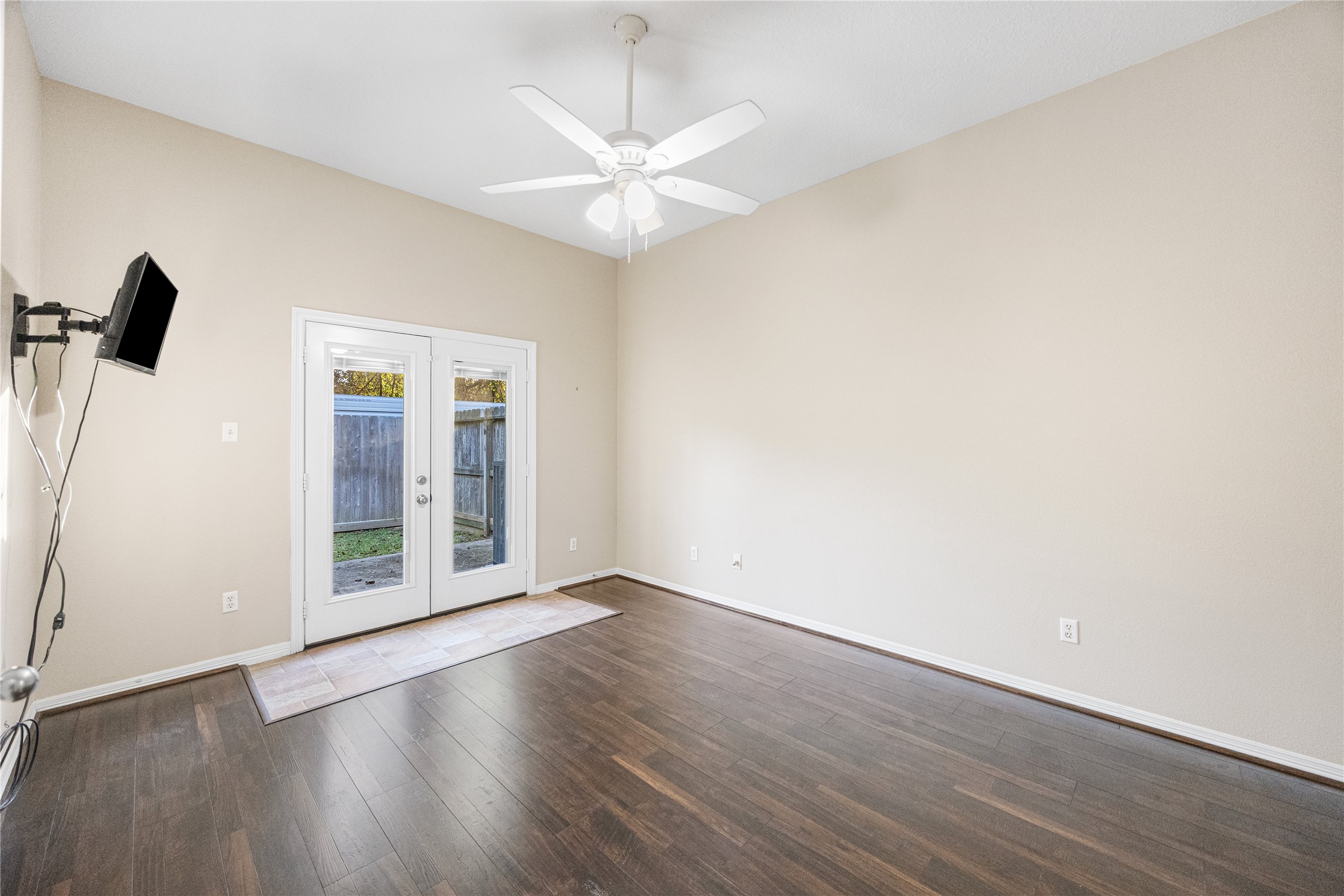 12755 Mill Ridge Drive, Unit 703 Cypress, TX 77429 - Photo 18 of 31 an empty room with wooden floor fan and windows