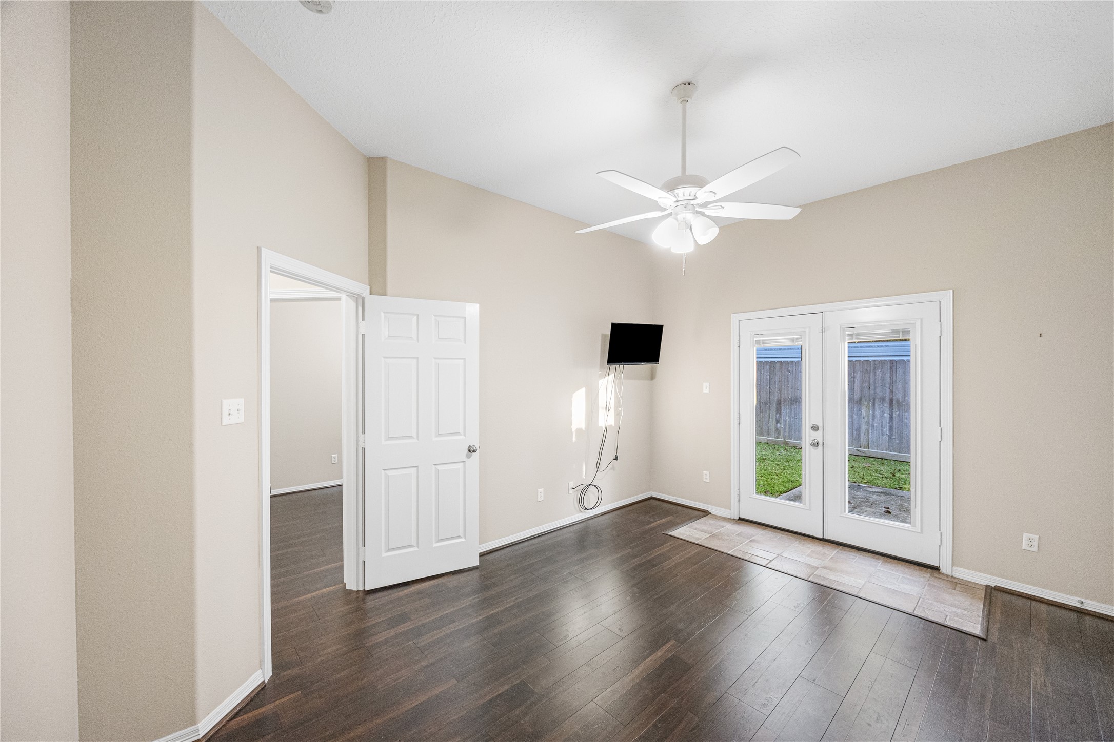 12755 Mill Ridge Drive, Unit 703 Cypress, TX 77429 - Photo 19 of 31 an empty room with wooden floor and ceiling fan