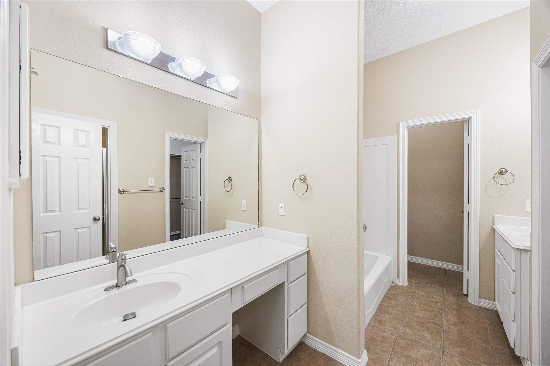 12755 Mill Ridge Drive, Unit 703 Cypress, TX 77429 - Photo 21 of 31 a bathroom with a sink a toilet and shower
