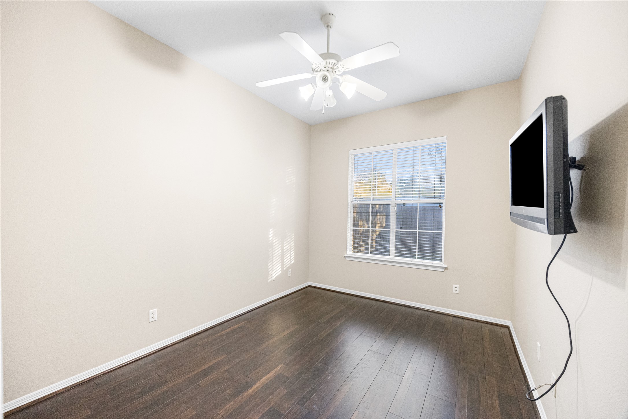 12755 Mill Ridge Drive, Unit 703 Cypress, TX 77429 - Photo 25 of 31 an empty room with wooden floor and windows
