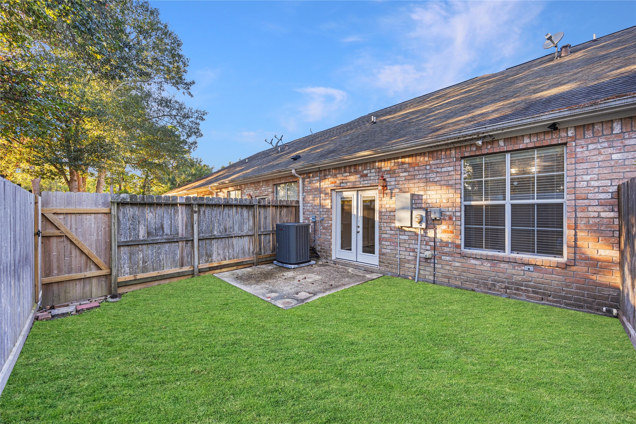 12755 Mill Ridge Drive, Unit 703 Cypress, TX 77429 - Photo 28 of 31 a view of a backyard with table and chairs and wooden fence