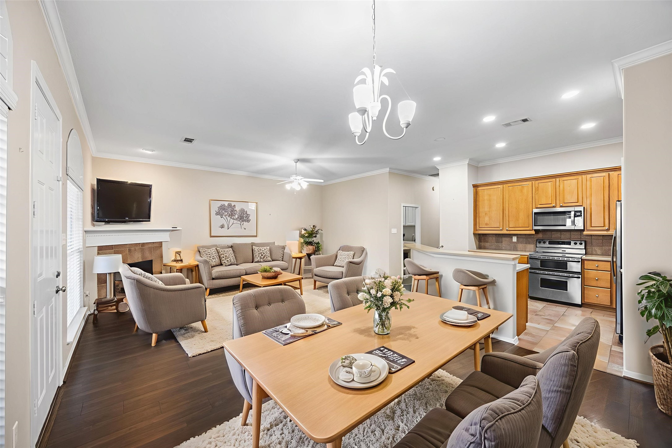 12755 Mill Ridge Drive, Unit 703 Cypress, TX 77429 - Photo 7 of 31 a view of a dining room with furniture a kitchen and chandelier