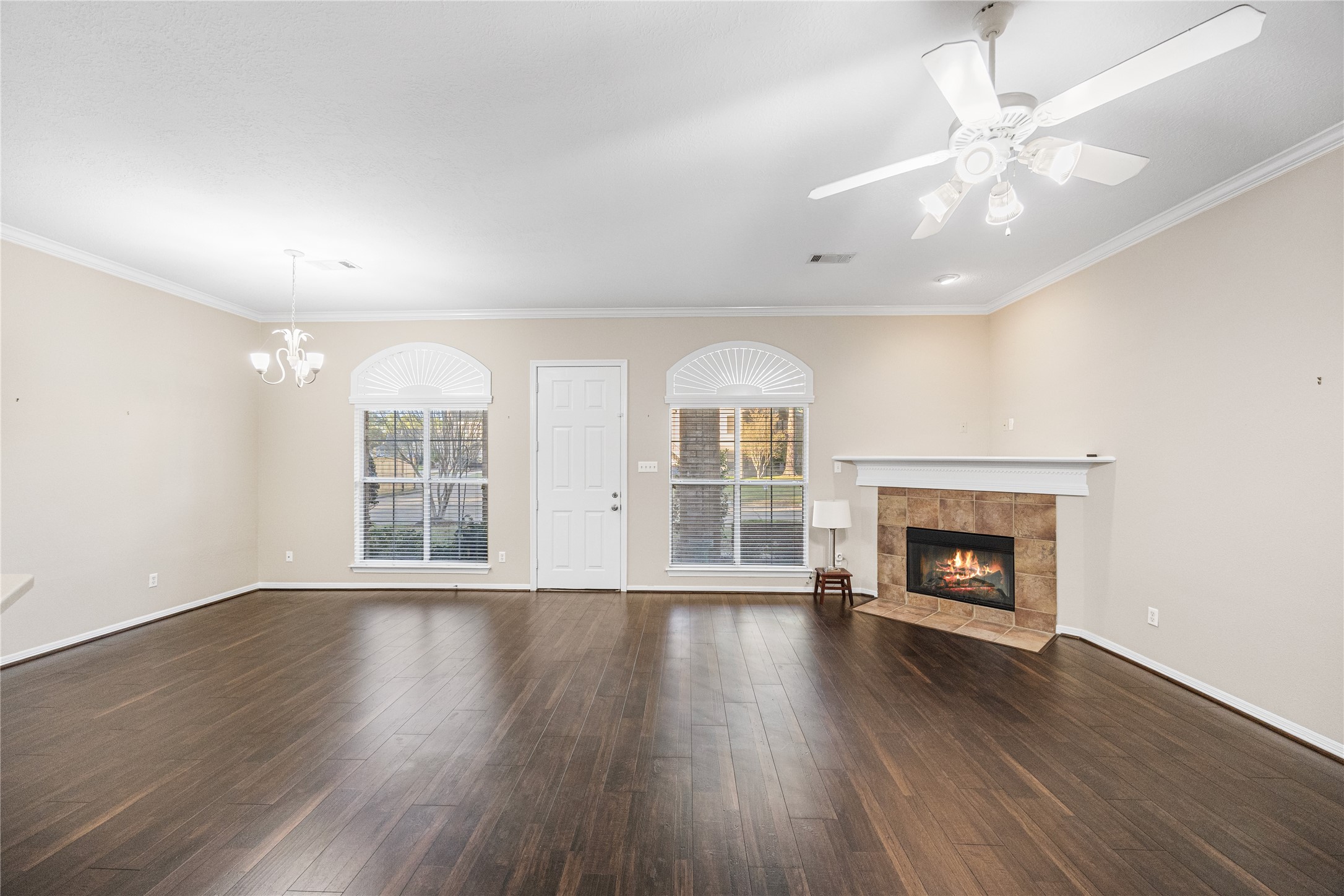 12755 Mill Ridge Drive, Unit 703 Cypress, TX 77429 - Photo 9 of 31 an empty room with wooden floor fireplace and windows