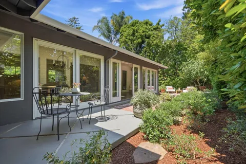 a view of a patio with table and chairs and potted plants