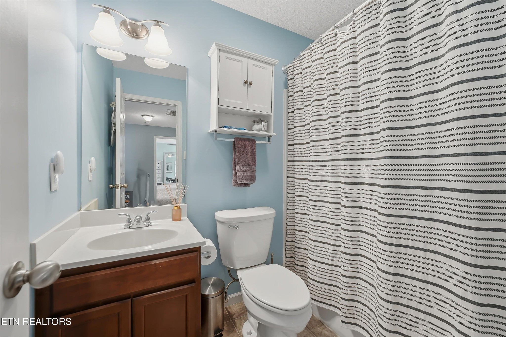 8508 Bowsong Lane Powell, TN 37849 - Photo 17 of 28 a bathroom with a toilet a sink and mirror