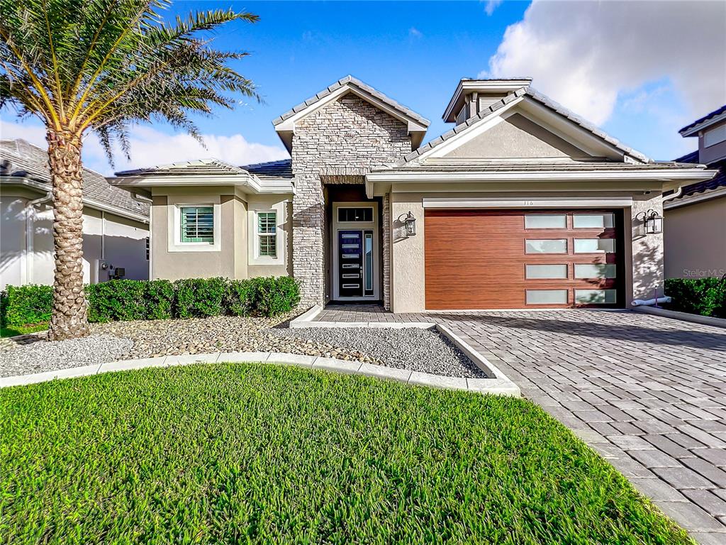 116 Hampton Loop Davenport, FL 33837 - Photo 1 of 1 a front view of a house with a yard and garage