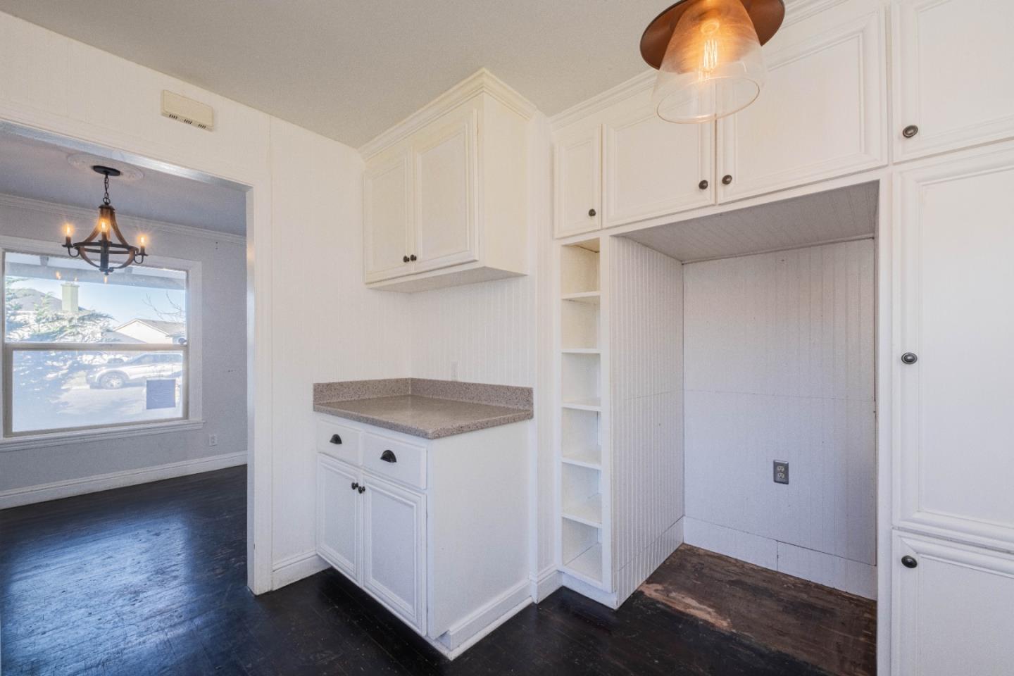 89 Clark Street Salinas, CA 93901 - Photo 14 of 35 an empty room with wooden floor cabinet and windows