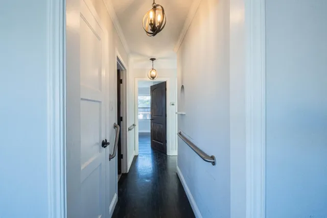 a view of a hallway with wooden floor