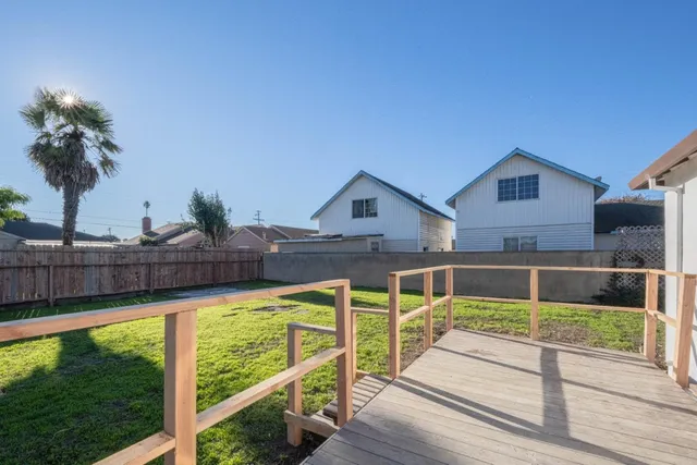 a view of a house with wooden floor and a yard