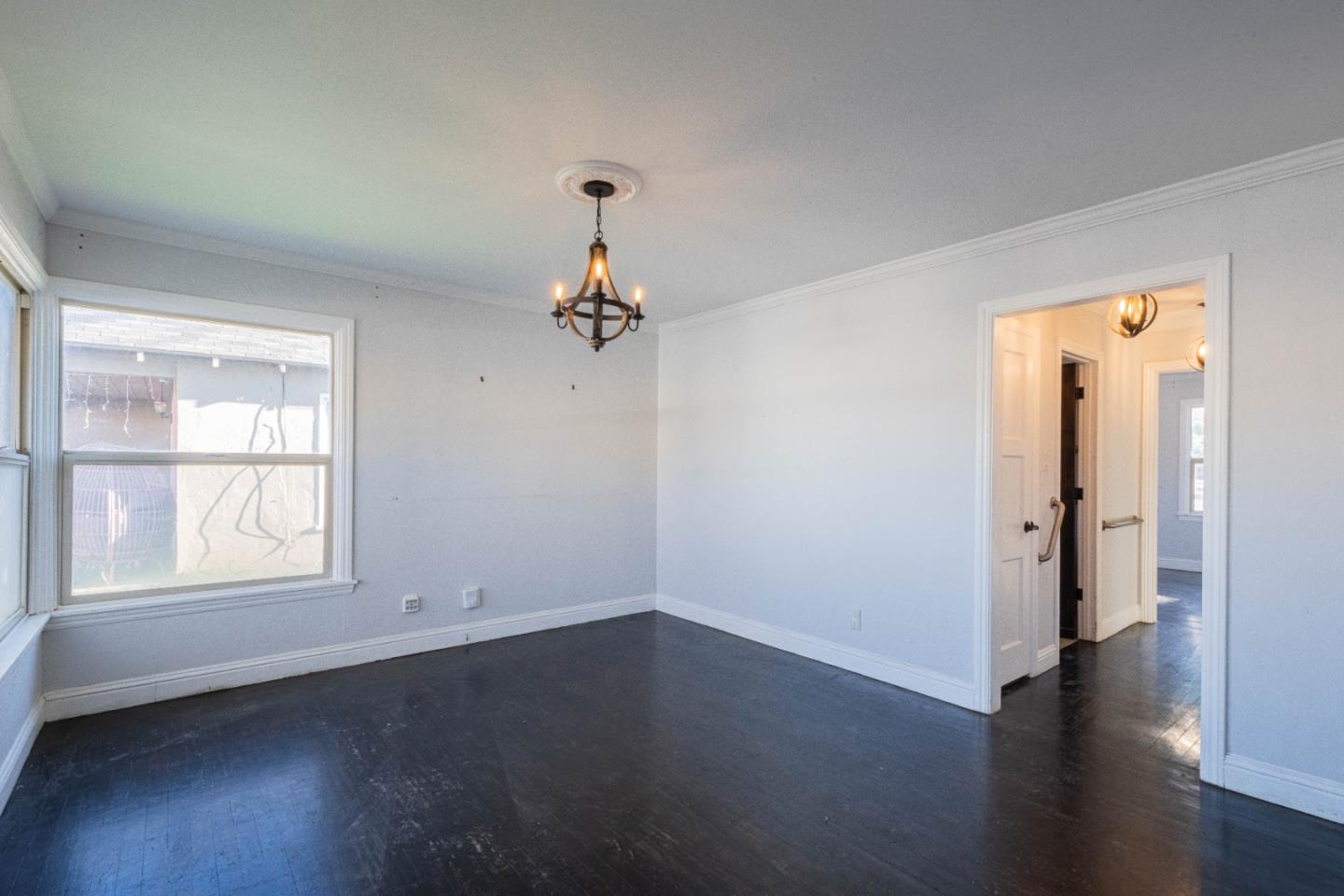 89 Clark Street Salinas, CA 93901 - Photo 7 of 35 an empty room with wooden floor and windows