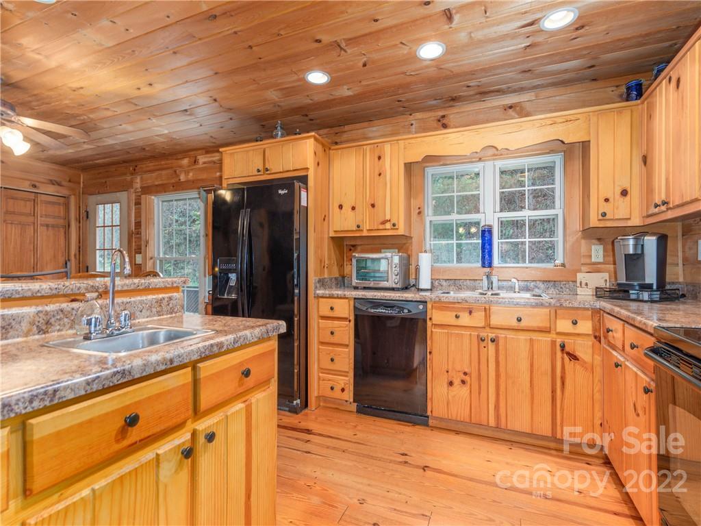 839 Price Town Road Clyde, NC 28721 - Photo 11 of 27 a kitchen with stainless steel appliances granite countertop a refrigerator and a sink