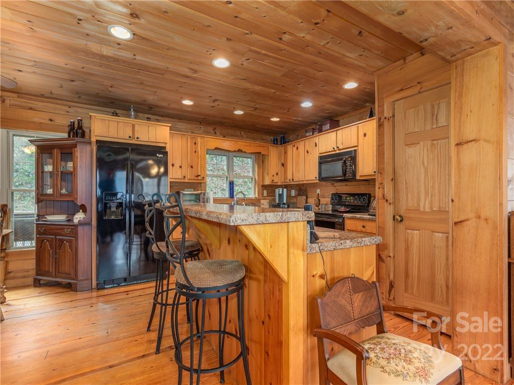 839 Price Town Road Clyde, NC 28721 - Photo 13 of 27 a kitchen with stainless steel appliances granite countertop a refrigerator and microwave