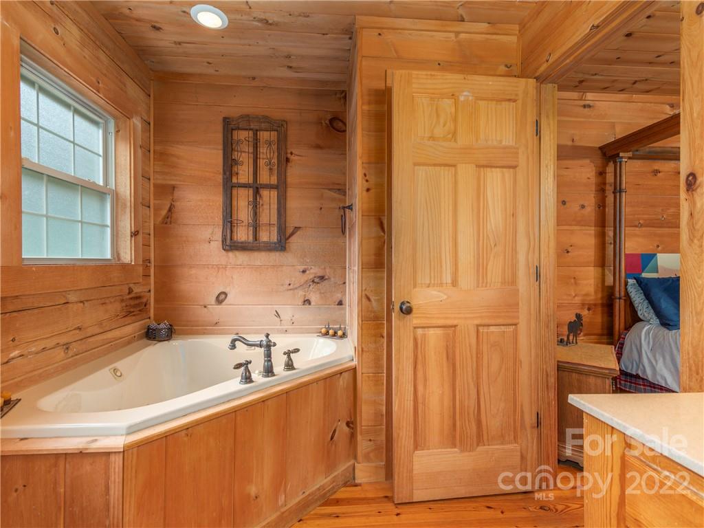 839 Price Town Road Clyde, NC 28721 - Photo 18 of 27 a bathroom with a tub and a sink