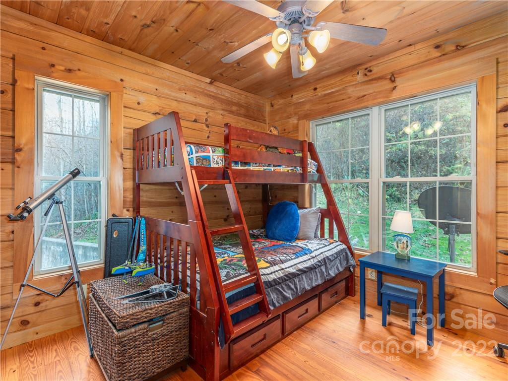 839 Price Town Road Clyde, NC 28721 - Photo 19 of 27 a living room with furniture a ceiling fan and a rug