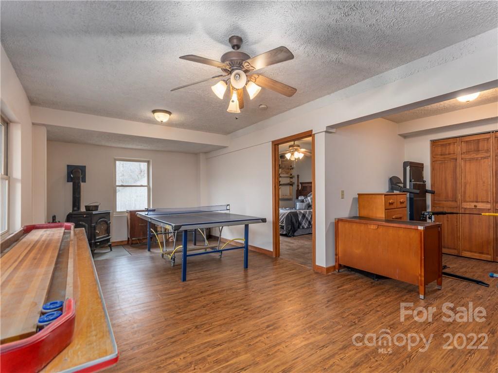 839 Price Town Road Clyde, NC 28721 - Photo 22 of 27 a living room with furniture and a wooden floor