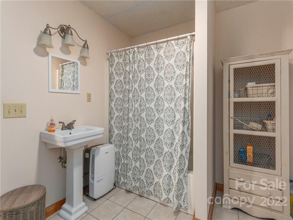 839 Price Town Road Clyde, NC 28721 - Photo 24 of 27 a bathroom with a sink toilet and shower