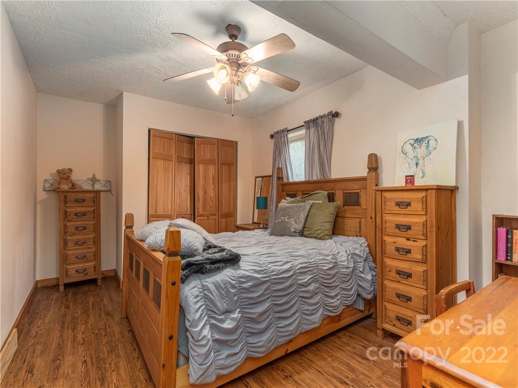 839 Price Town Road Clyde, NC 28721 - Photo 26 of 27 a bedroom with a bed and furniture