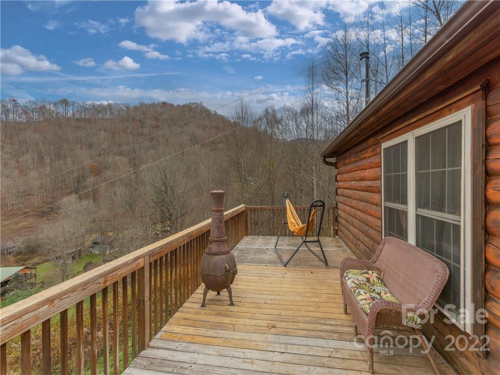 839 Price Town Road Clyde, NC 28721 - Photo 9 of 27 a terrace of a house with wooden floor and outdoor seating