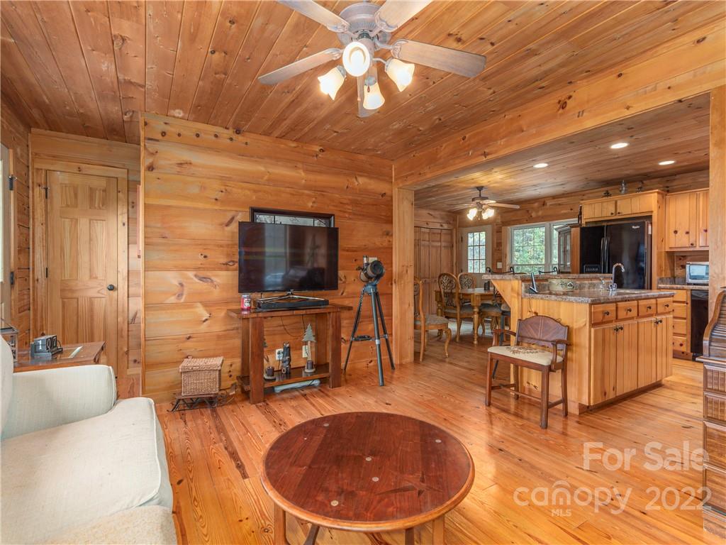 839 Price Town Road Clyde, NC 28721 - Photo 10 of 27 a living room with furniture a flat screen tv and kitchen view