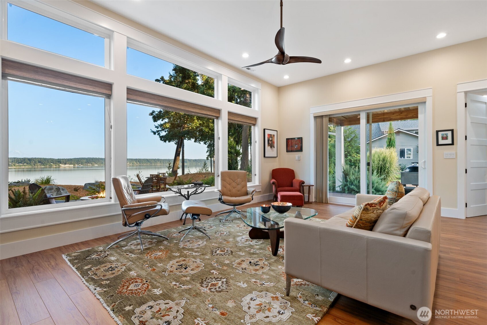 211 East Vineyard Crest Road Grapeview, WA 98546 - Photo 15 of 40 a living room with furniture large windows and wooden floor