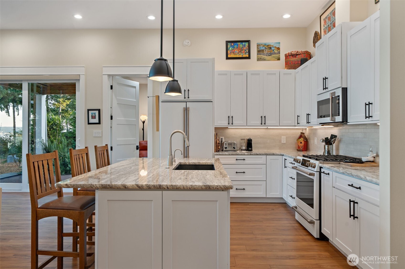211 East Vineyard Crest Road Grapeview, WA 98546 - Photo 17 of 40 a kitchen with white cabinets and stainless steel appliances