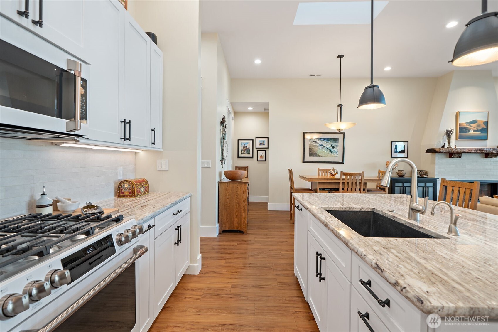 211 East Vineyard Crest Road Grapeview, WA 98546 - Photo 19 of 40 a kitchen with stainless steel appliances granite countertop a sink a stove and a wooden floors