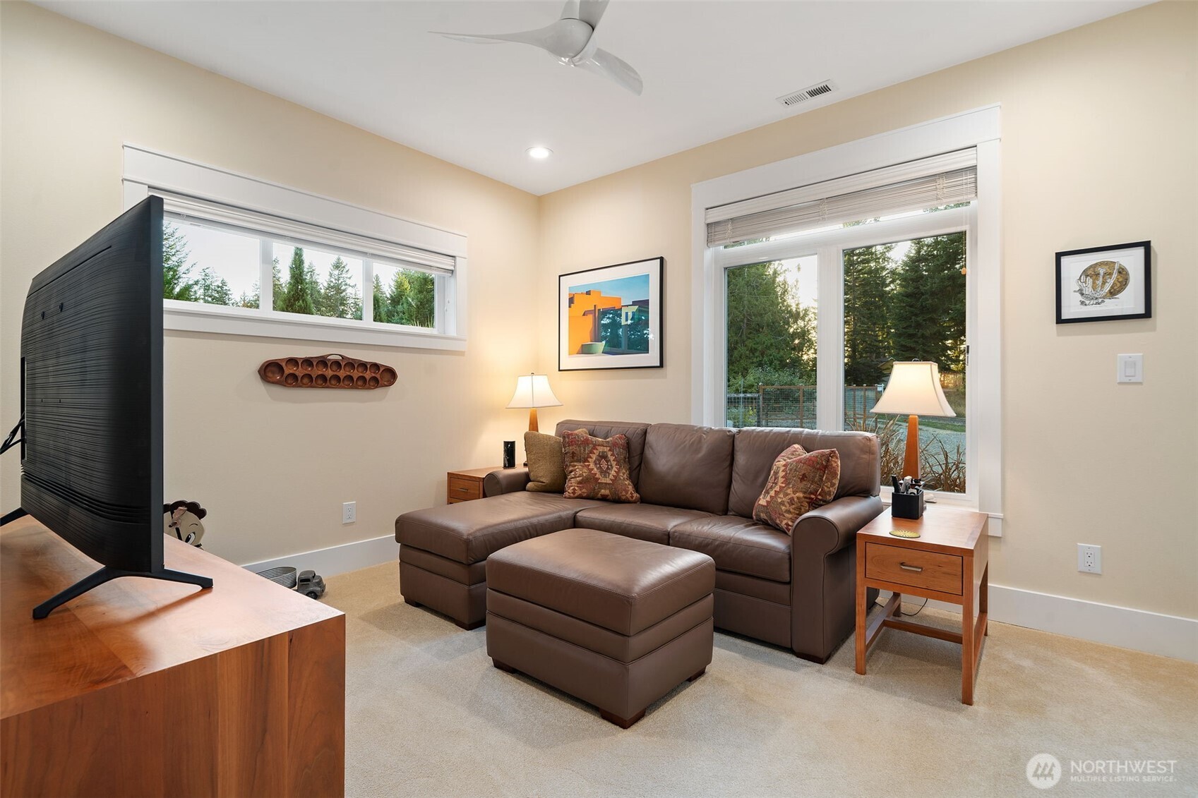 211 East Vineyard Crest Road Grapeview, WA 98546 - Photo 27 of 40 a living room with furniture and a flat screen tv