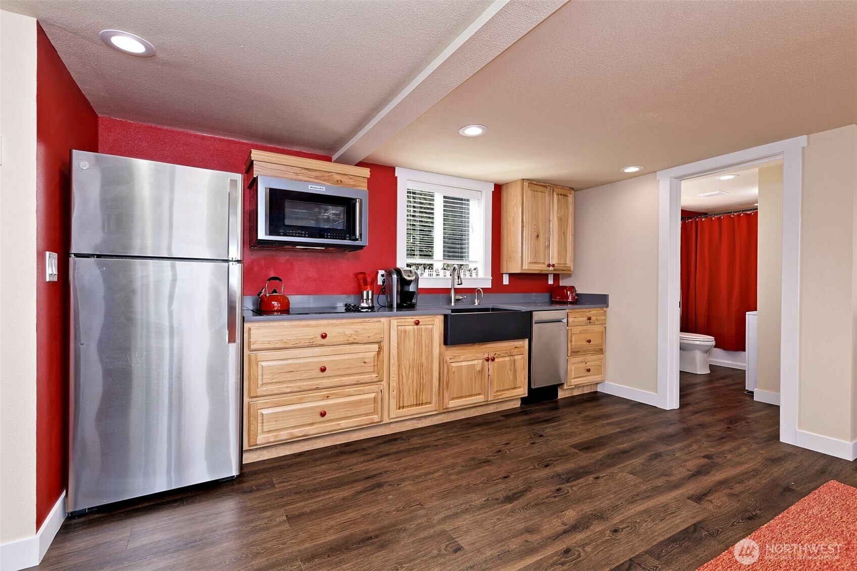 211 East Vineyard Crest Road Grapeview, WA 98546 - Photo 33 of 40 a kitchen with stainless steel appliances a refrigerator sink and wooden floor