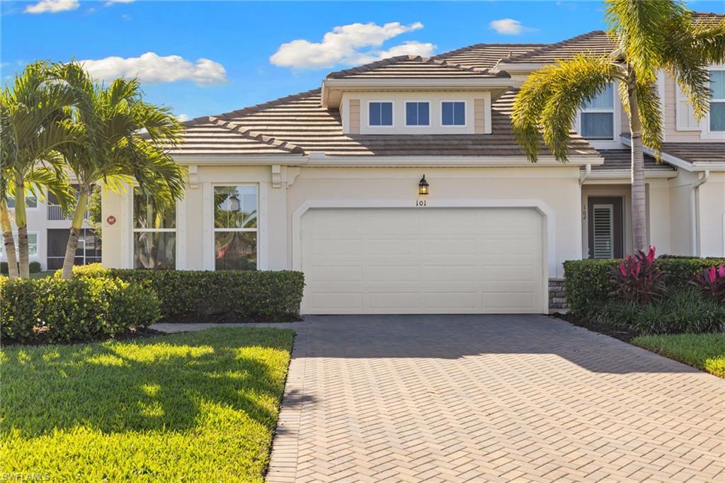 4619 Arboretum Circle, Unit 101 Naples, FL 34112 - Photo 2 of 41 a front view of a house with garden
