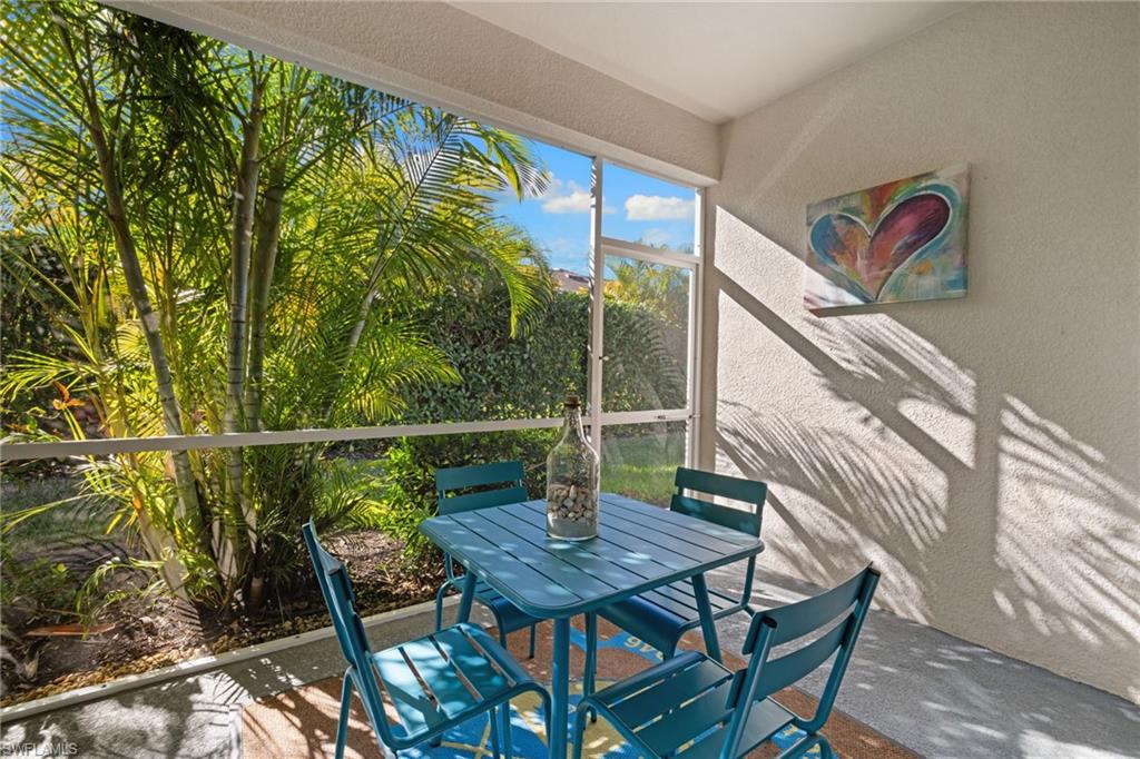 4619 Arboretum Circle, Unit 101 Naples, FL 34112 - Photo 28 of 41 a view of a chairs and table in patio