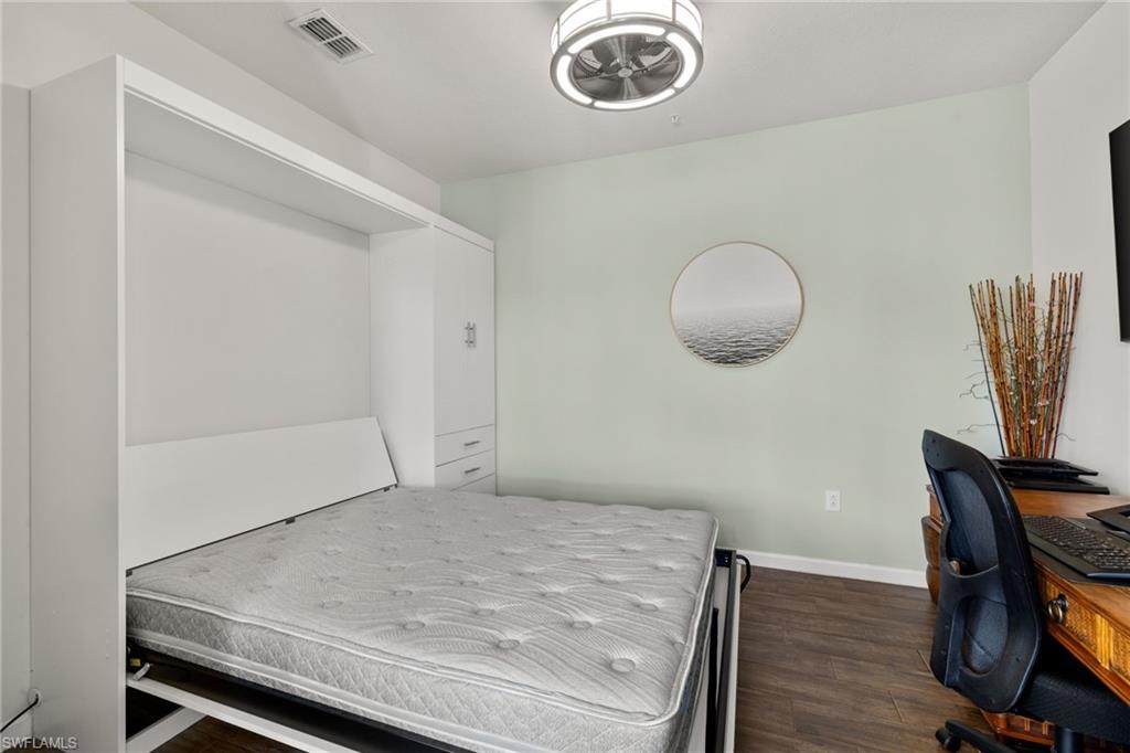 4619 Arboretum Circle, Unit 101 Naples, FL 34112 - Photo 34 of 41 a room with a table and a chair