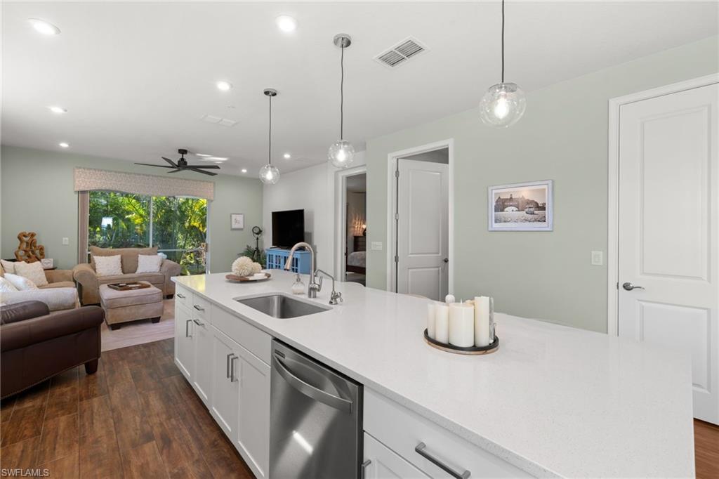 4619 Arboretum Circle, Unit 101 Naples, FL 34112 - Photo 9 of 41 a kitchen with a sink appliances and a counter top space
