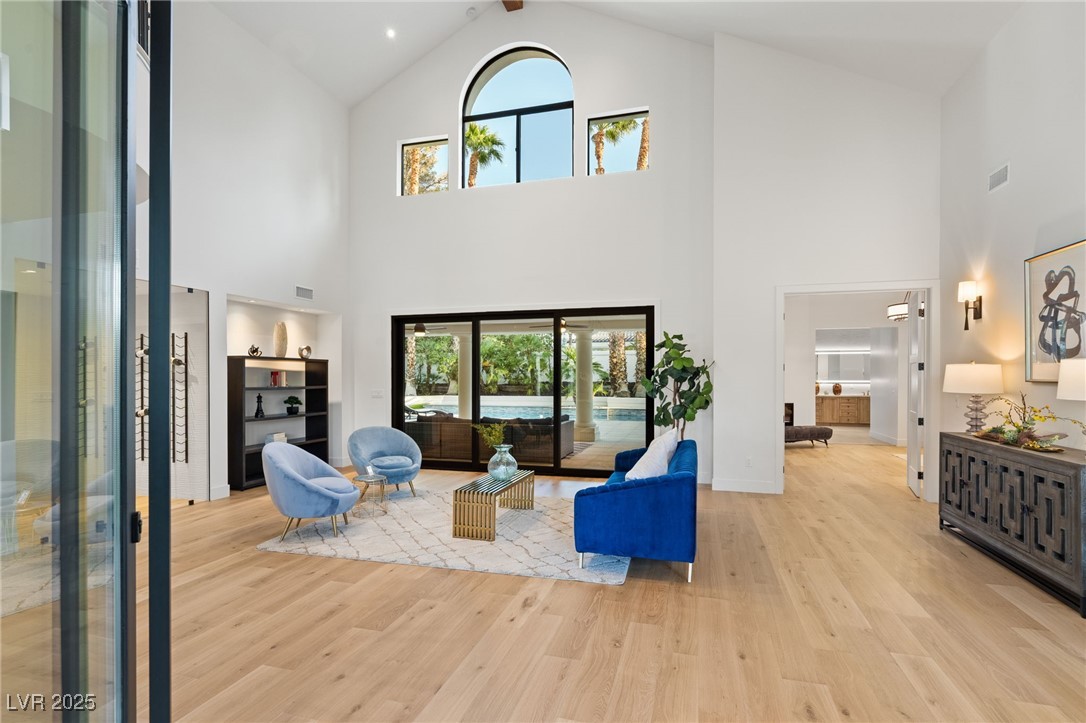 2316 Prometheus Court Henderson, NV 89074 - Photo 4 of 92 Living area featuring wood finished floors, high vaulted ceiling, visible vents, and a healthy amount of sunlight