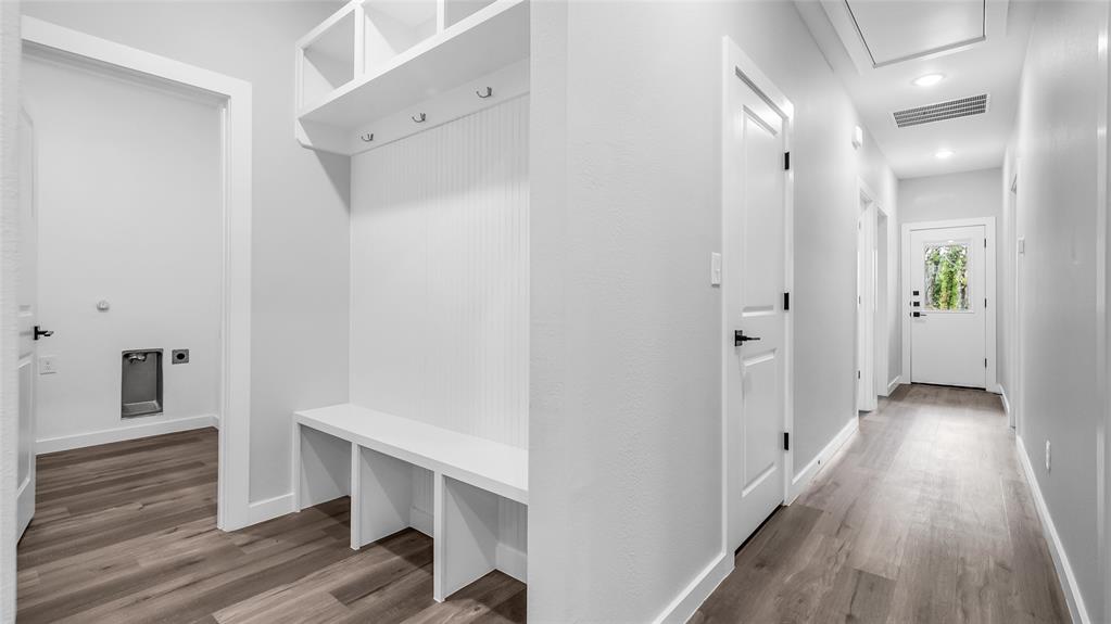 716 East Chestnut Street Denison, TX 75021 - Photo 13 of 26 Mudroom area featuring a built-in bench, storage cubbies, and coat hooks