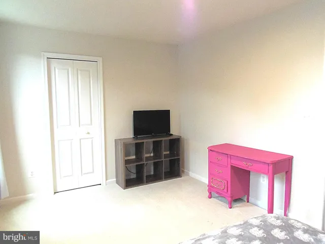 a room with a bed and flat screen tv