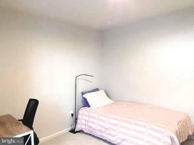 a bedroom with a bed and chair