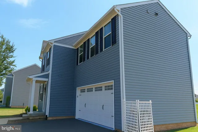 a front view of a house with garage