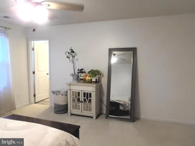 a view of kitchen with furniture and refrigerator