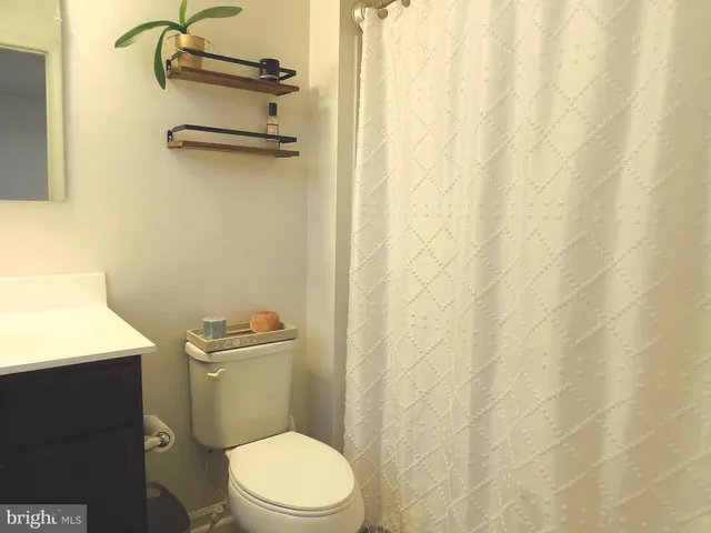 a white toilet sitting next to a bathroom sink
