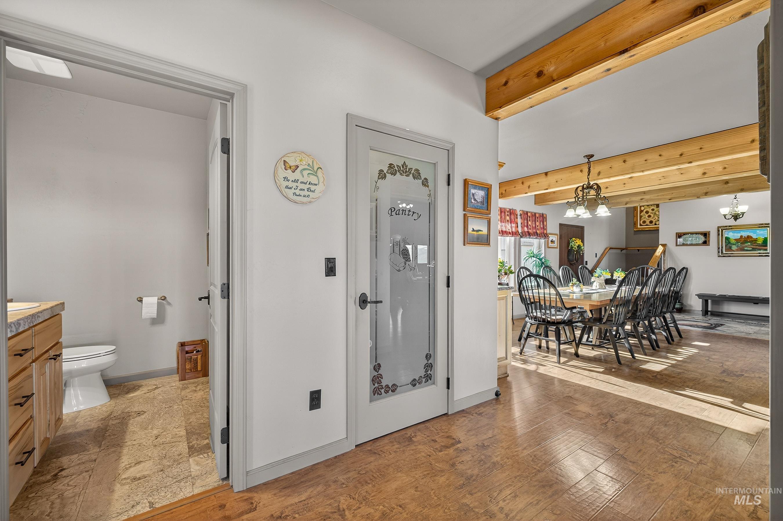 2195 Kilborn Lane Mesa, ID 83643 - Photo 11 of 50 Foyer with beam ceiling, a chandelier, and light wood-style floors
