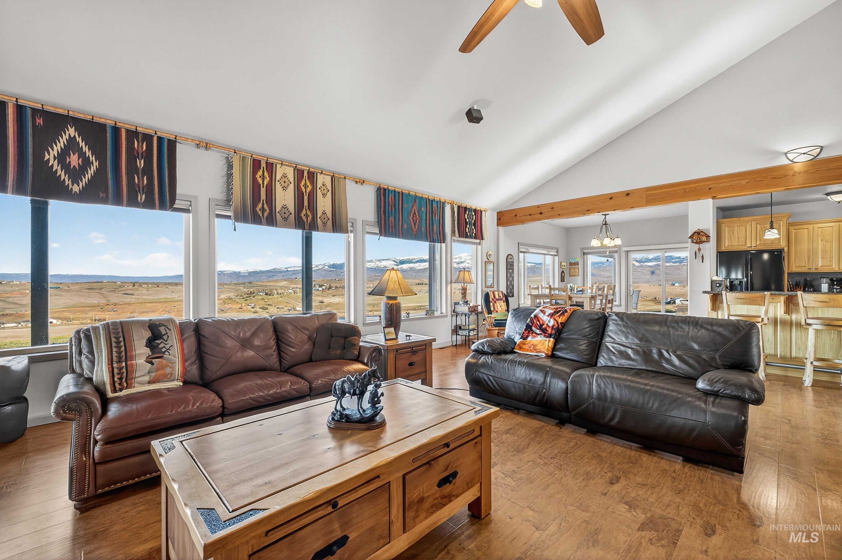 2195 Kilborn Lane Mesa, ID 83643 - Photo 16 of 50 Living room with a chandelier, hardwood / wood-style floors, plenty of natural light, and high vaulted ceiling