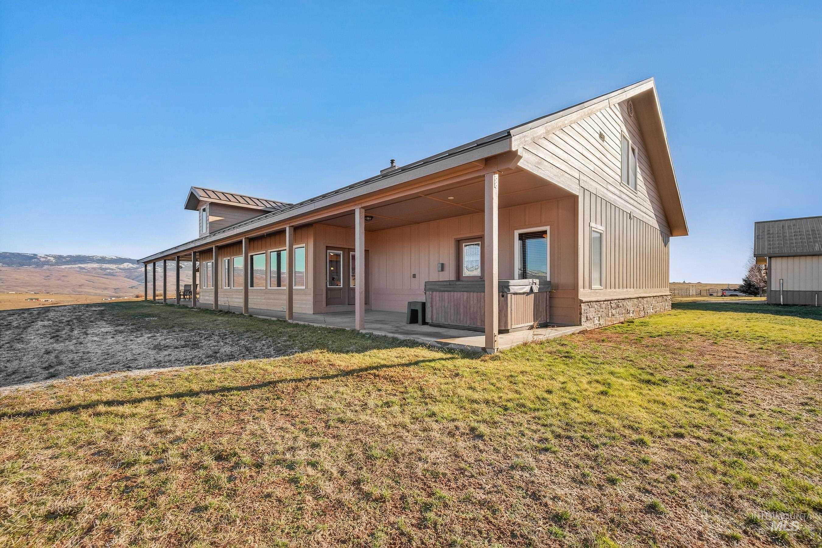 2195 Kilborn Lane Mesa, ID 83643 - Photo 46 of 50 View of home's exterior with a lawn, stone siding, and a patio area
