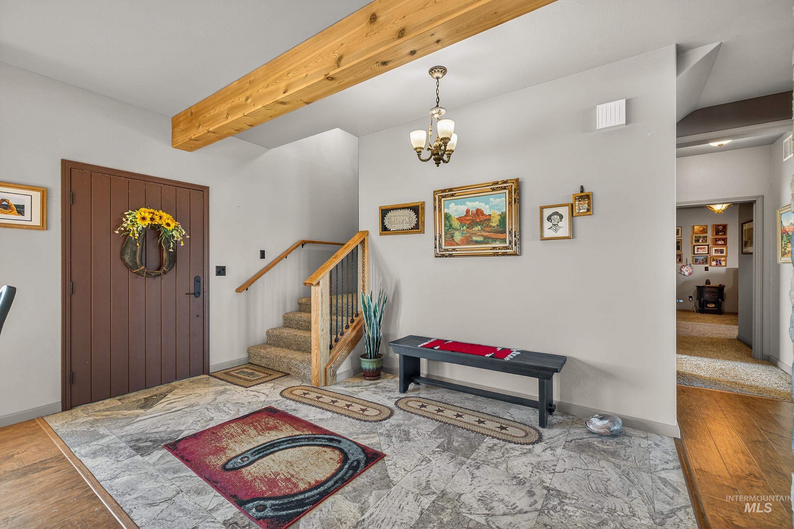 2195 Kilborn Lane Mesa, ID 83643 - Photo 5 of 50 Foyer entrance with beamed ceiling, light wood-style floors, a chandelier, and stairway