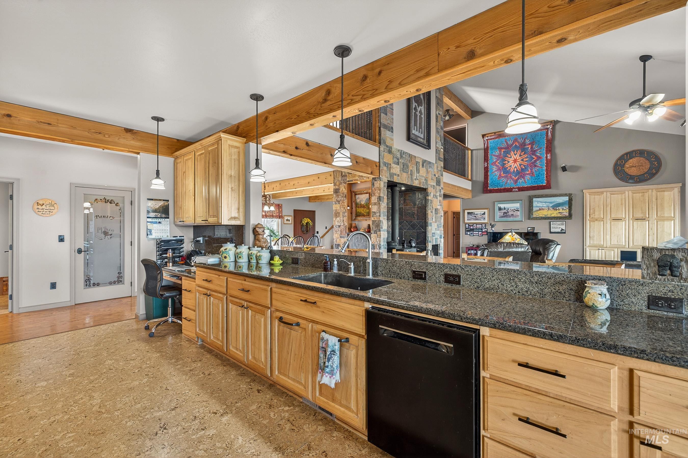 2195 Kilborn Lane Mesa, ID 83643 - Photo 50 of 50 Kitchen with decorative light fixtures, black dishwasher, open floor plan, beamed ceiling, and dark stone counters