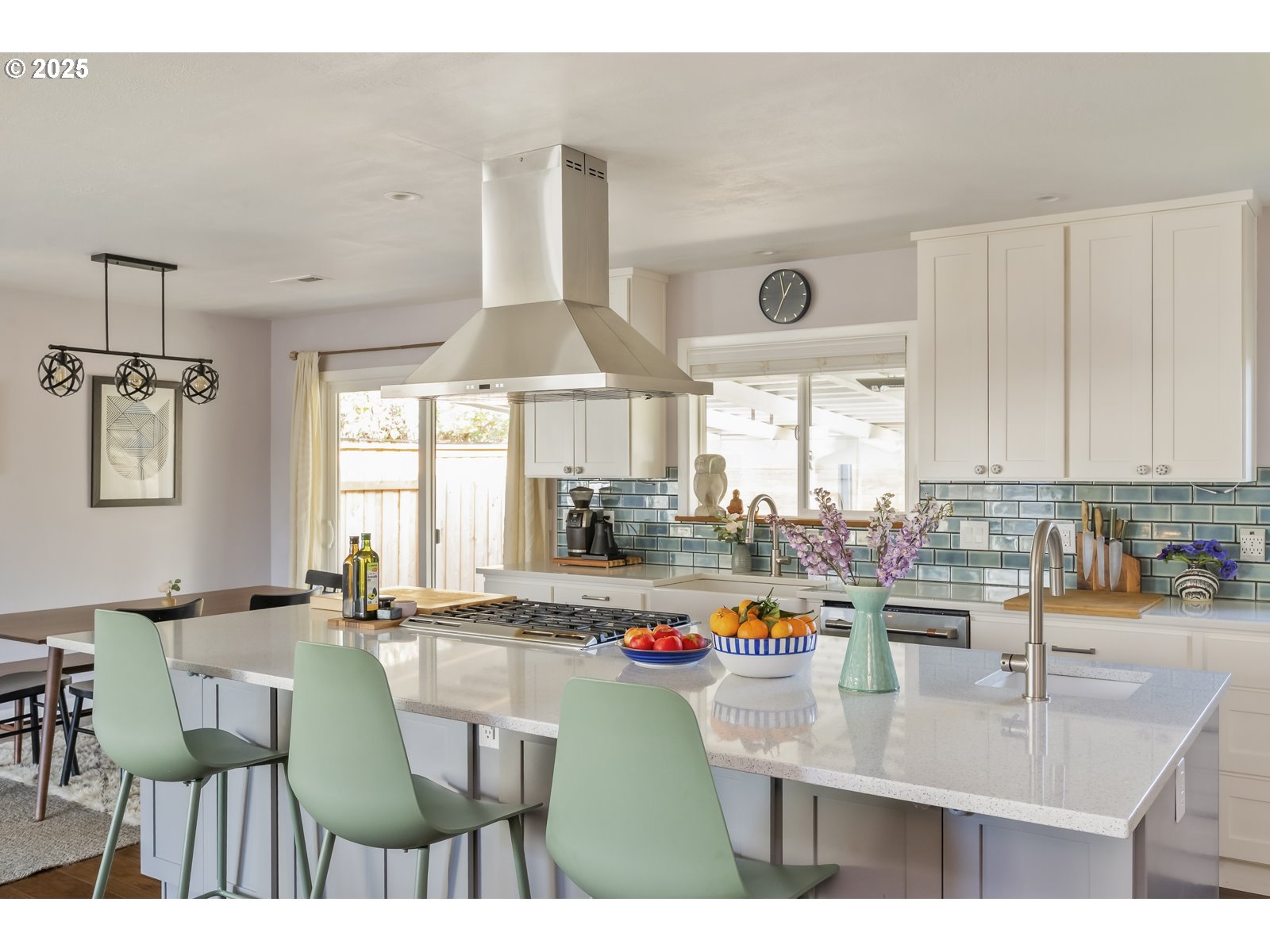 4642 Southeast 31st Avenue Portland, OR 97202 - Photo 8 of 45 a kitchen with kitchen island granite countertop a sink a counter top space and living room view