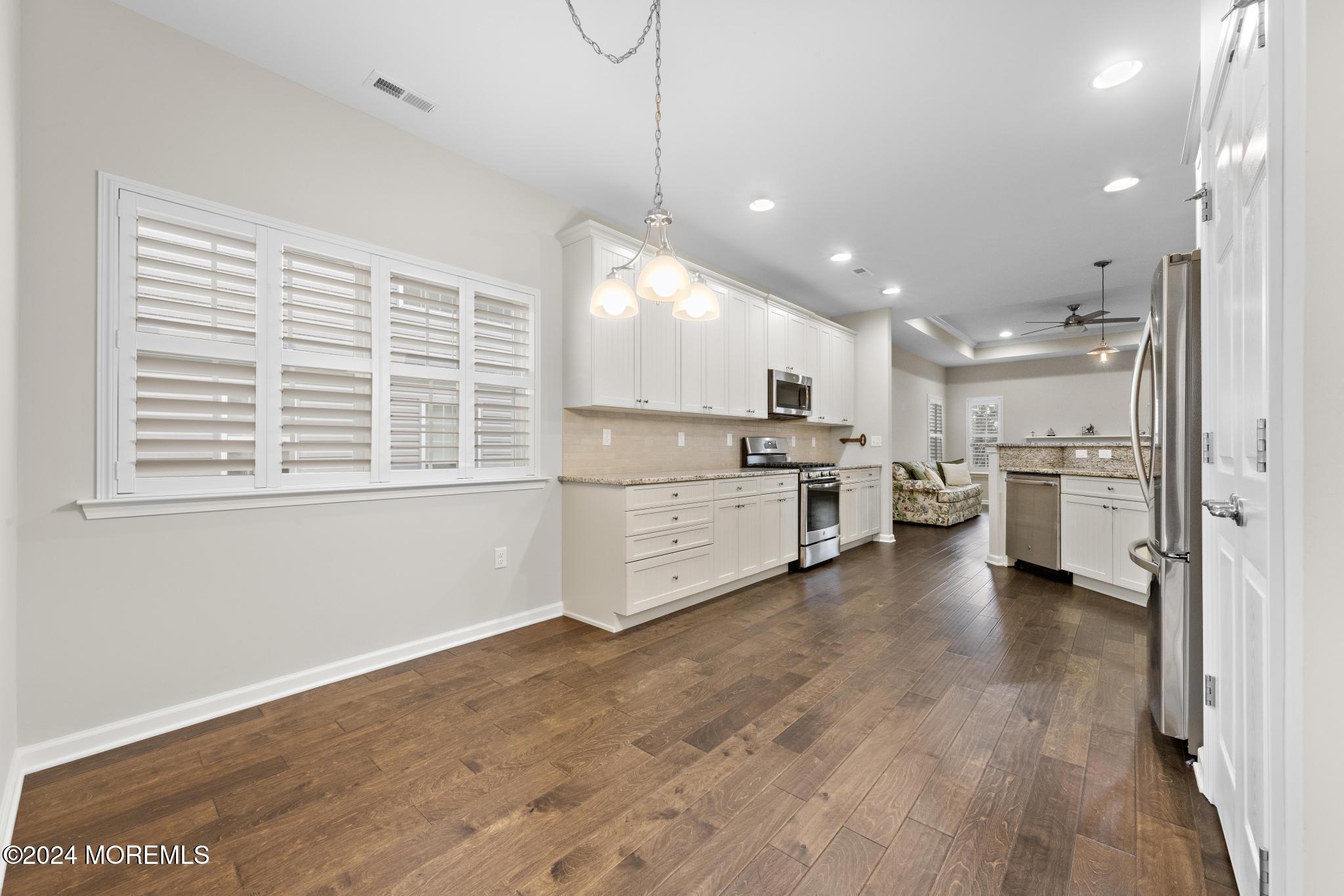 31 Garden Path Barnegat, NJ 08005 - Photo 7 of 54 a view of a kitchen with kitchen island a sink wooden floor and stainless steel appliances
