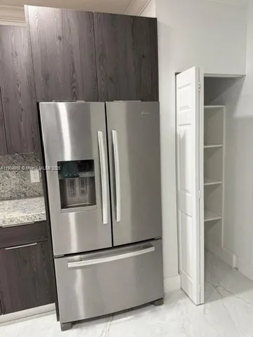 a view of kitchen with wooden floor and electronic appliances