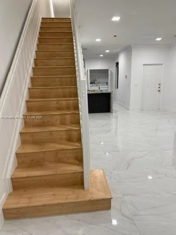 a view of entryway with wooden cabinet