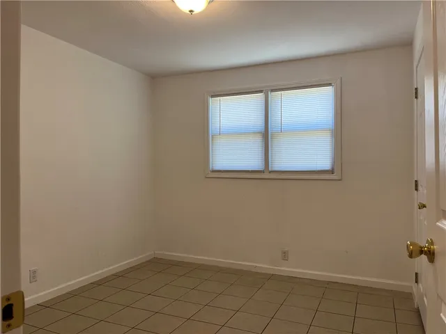 a view of backyard with wooden fence